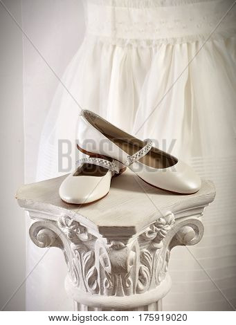 Two white shoes on a expositor background