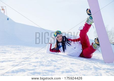 Athlete with snowboard in snow in mountains