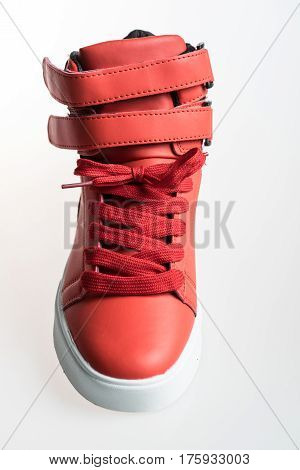 Fashion shoes with shoestring. Red sneaker and shoelace isolated on white background