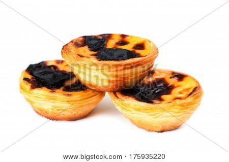 Creamy sweet egg curstard with black crust and sugar powder isolated on white. Pasteis de Nata egg tart