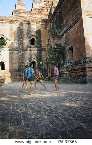 Myanmar Pagan - 06.11.2011: Locals play with kicking ball chinlon in the popular game sepak takraw