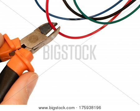 Cutting red wire by wire cutters. Safety precautions bomb neutralization
