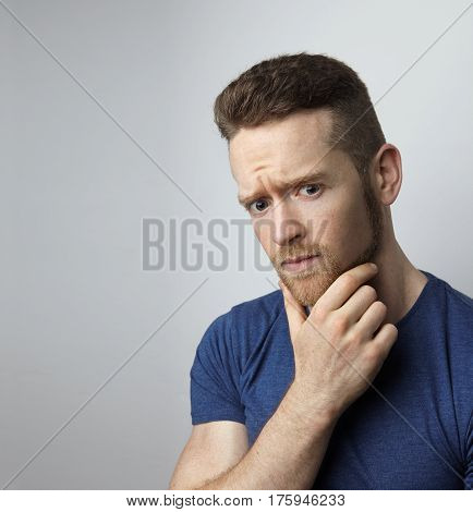 Closeup portrait of sad young man with worried stressed face expression. Obsessive compulsive, anxiety disorders.