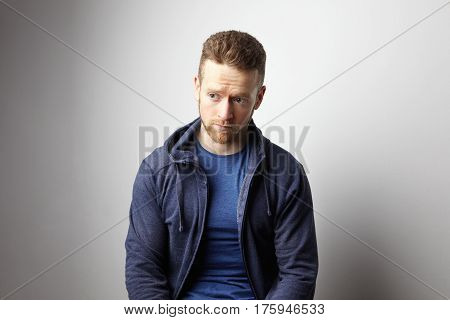 Closeup portrait of sad young man with worried stressed face expression. Obsessive compulsive, anxiety disorders.
