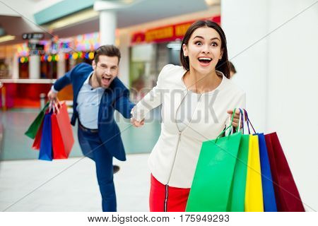 Hurry Faster! It's Shopping Time And Fun. Handsome Cheerful  Successful Happy  Man  Holding Hands An