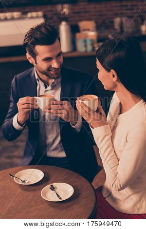 Happy Romantic Man And Woman  Sitting In A Cafe Drinking Coffee