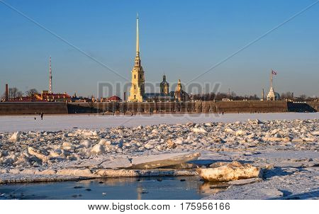 Peter and Paul Fortress in winter. St. Petersburg, Russia. In the foreground is the water of the channel.
