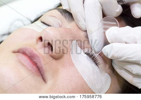 Woman on the procedure for eyelash extensions, eyelashes lamination