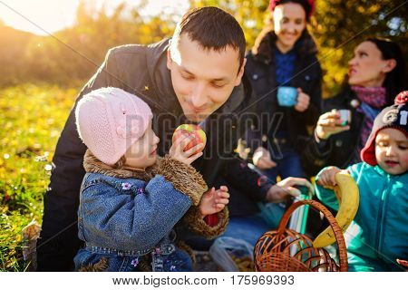 Girl Sitting On The Grass With An Apple In His Hand