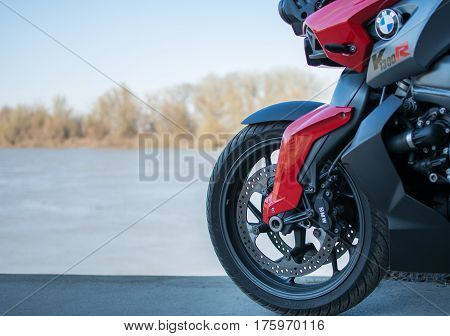 Senta, Serbia: March 4th, 2017. Back wheel of beautiful Red-grey BMW K1300R motorcycle, photographed outdoor in Senta, on a public walk way near river Tisa