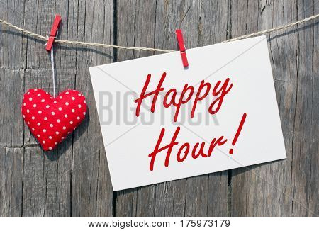 Happy Hour - postcard with red heart on wooden background