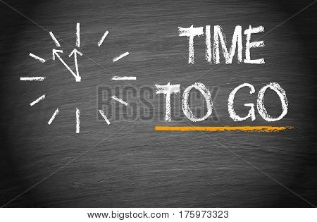 Time to go - clock with text on chalkboard background