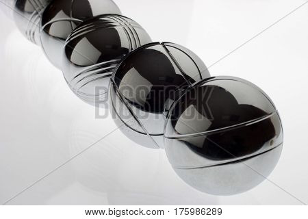 A Single row of metal bocce balls