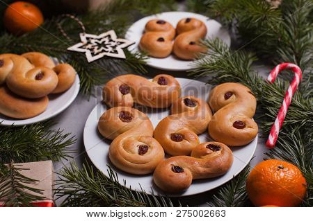 Swedish Christmas. Traditional Swedish Buns On Cake Stand In Christmas Setting. A Saffron Bun, In Sw