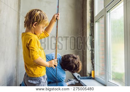 Father And Son Repair Windows Together. Repair The House Yourself