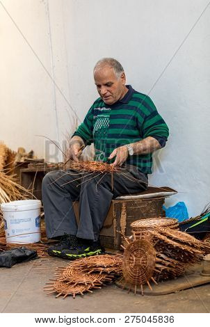 Camacha, Madeira, Portugal - April 19, 2018: A Basket Weaver At Work In The Factory Shop In Camacha 