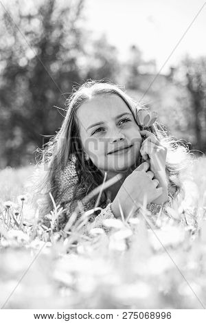 Child Enjoy Spring Sunny Day While Lying At Meadow.seasonal Allergy Concept. Girl On Dreamy Face Hol