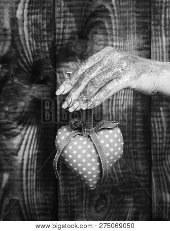Female Hand Smeared In Golden Paint Or Glister Holding Handmade Pink Polka Dots Valentine Heart On B