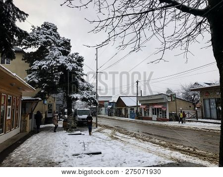 Bakuriani, Georgia - November 17, 2018: Winter Noon. People Walk In The Snow. Snowy Street. Mountain