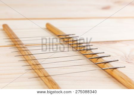 Table With Needles For Acupuncture. Silver Needles For Traditional Chinese Acupuncture Medicine On A
