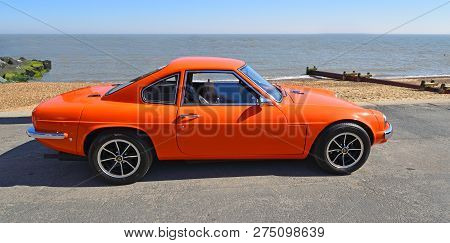 Felixstowe, Suffolk, England - May 06, 2018:  Classic Orange Ginetta Motor Car Parked On Seafront  P