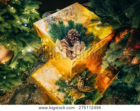 Christmas Still Life From The Scenery Of Gifts Under The Tree With Luminous Garlands. Golden Gifts U