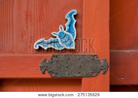 Nagasaki, Japan - October 24, 2018: Lucky bat symbol decoration woodcarved on a door at Sofukuji Temple  