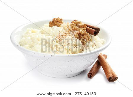 Creamy Rice Pudding With Cinnamon And Walnuts In Bowl On White Background