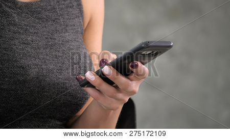 Female Hands Texting On Screen Smart Phone.