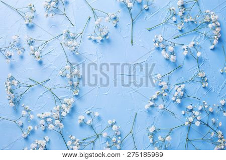 Frame  From Fresh White Gypsofila  Flowers On Blue Textured Background. Top View. Flat Lay. Place Fo
