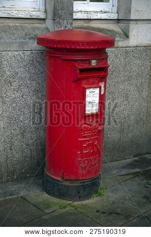 Editorial Swansea, Uk - December 20, 2018: The Bilingual Welsh And English Roadside British Red Post