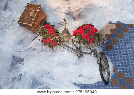 Old Retro Tandem Bicycle And Christmas Decors, Red Flowers. Travel Photo 2018. December.
