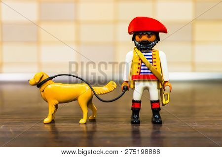 Poznan, Poland - December 22, 2018: Playmobil Toy Pirate Walking Her Dog Out With A Line In Soft Foc