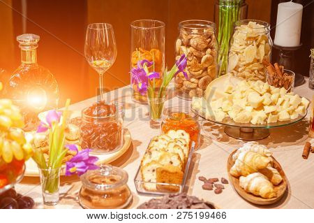 Closeup Degustation Premium Brandy With Snacks, Fresh And Dried Fruits, Pieces Parmesan Cheese, Hone