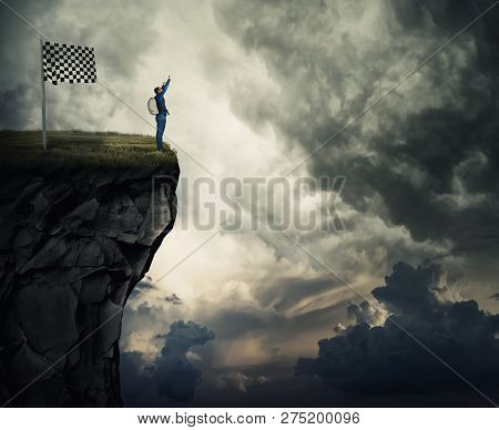 Surreal View As A Young Man With A Backpack Raising Hands Up Celebrating Victory On The Top Of A Hil