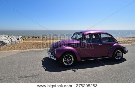 Felixstowe, Suffolk, England - May 06, 2018:  Classic Purple  Vw Beetle Motor Car Being Driven Along
