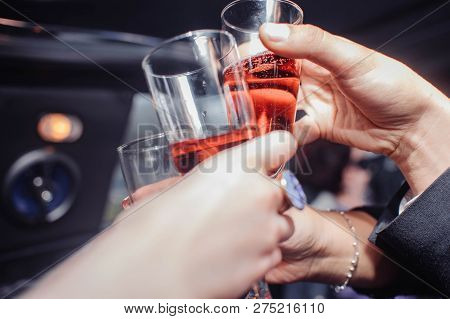 Hands Of People Hold Glasses In Their Hands And Touch Them At The Celebration