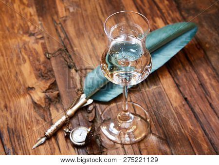 Grappa In A Small Glas On Old Wooden Table