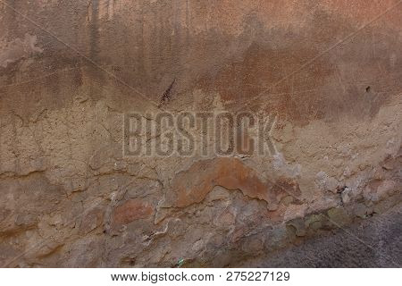 The Old Shabby Wall, Which Shows Several Layers Of Old Plaster, Scratching, And Traces Of The Old Pa