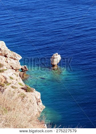 Europe, Greece, Acre Of Ireo, Waves Slowly Erode A
 Lonely Rock In The Gulf Of Corinth