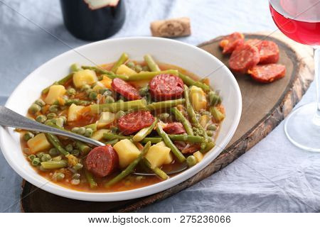 Italian soup minestrone with fuet sausage