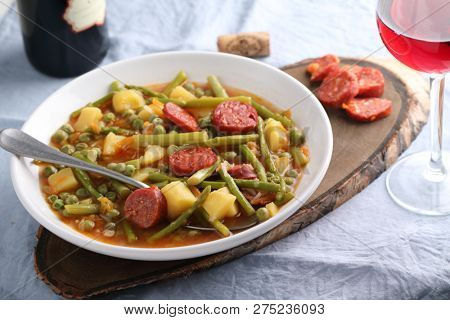 Italian soup minestrone with fuet sausage