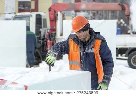 Portrait Of A Fitter Slinger In An Orange Vest And Helmet On Unloading Ice Plates