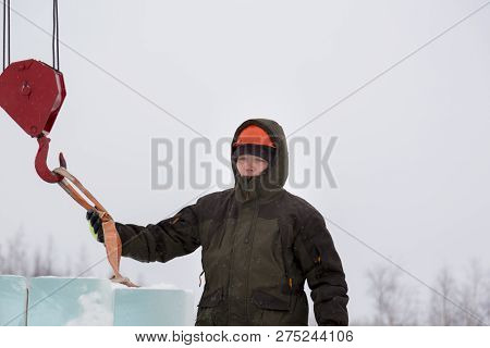 Portrait Of A Fitter Slinger In A Jacket And Helmet On The Unloading Of Ice Plates