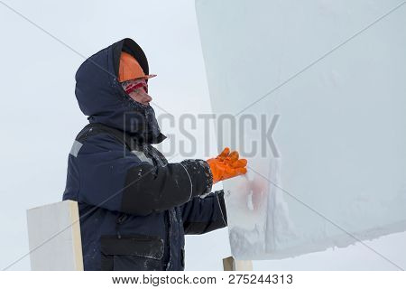 Portrait Of A Fitter Slinger In A Jacket And Helmet On The Unloading Of Ice Plates