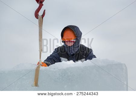 Portrait Of A Fitter Slinger In A Jacket And Helmet On The Unloading Of Ice Plates