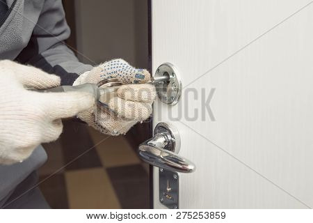 Locksmith In Rag Gloves Changes The Door Locks.