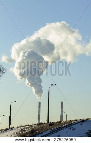 Smoke From Industrial Chimneys Against The Blue Sky. Pollution.