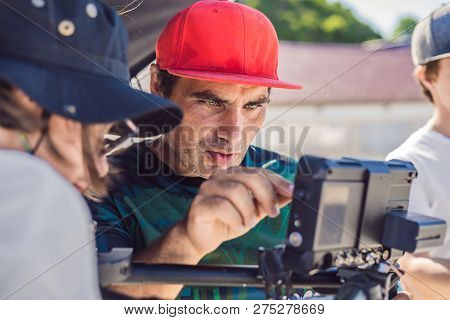 Steadicam Operator And His Assistant Prepare Camera And 3-axis Stabilizer-gimbal For A Commercial Sh