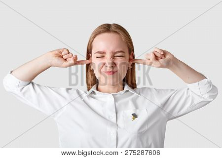 Stressful Woman Pluggs Ears In Despair, Frowns Face With Discontent, Ignores Unpleasant Conflict Sit